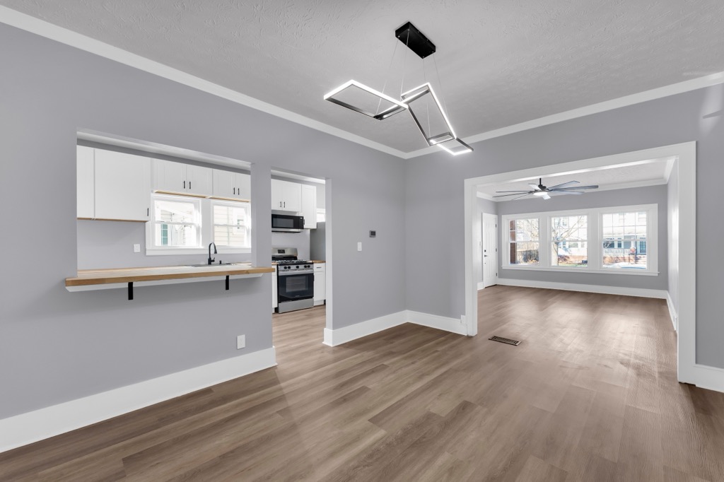 Dining room after renovation with the pass-through to the kitchen and the living room beyond.