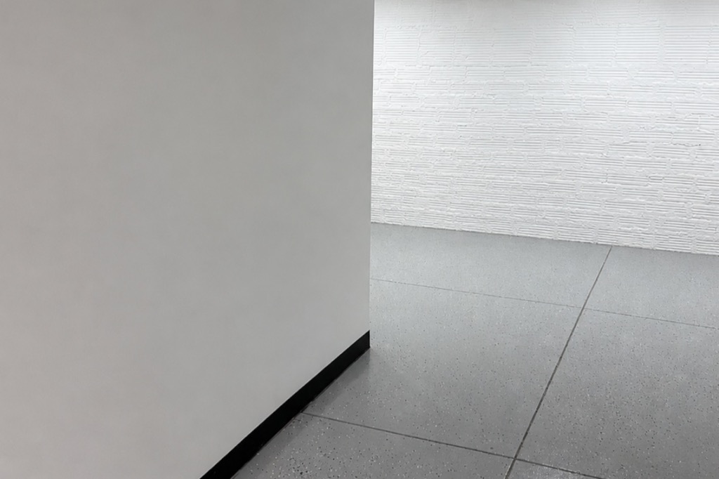 Basement after renovation: painted walls, black base, epoxy floor.