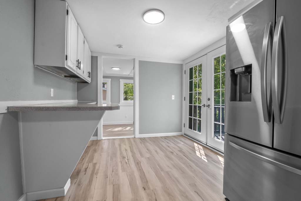 Kitchen counter after renovation, looking toward the dining area and french doors.