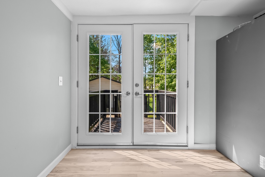 Interior french doors after renovation, opening onto the rear deck.