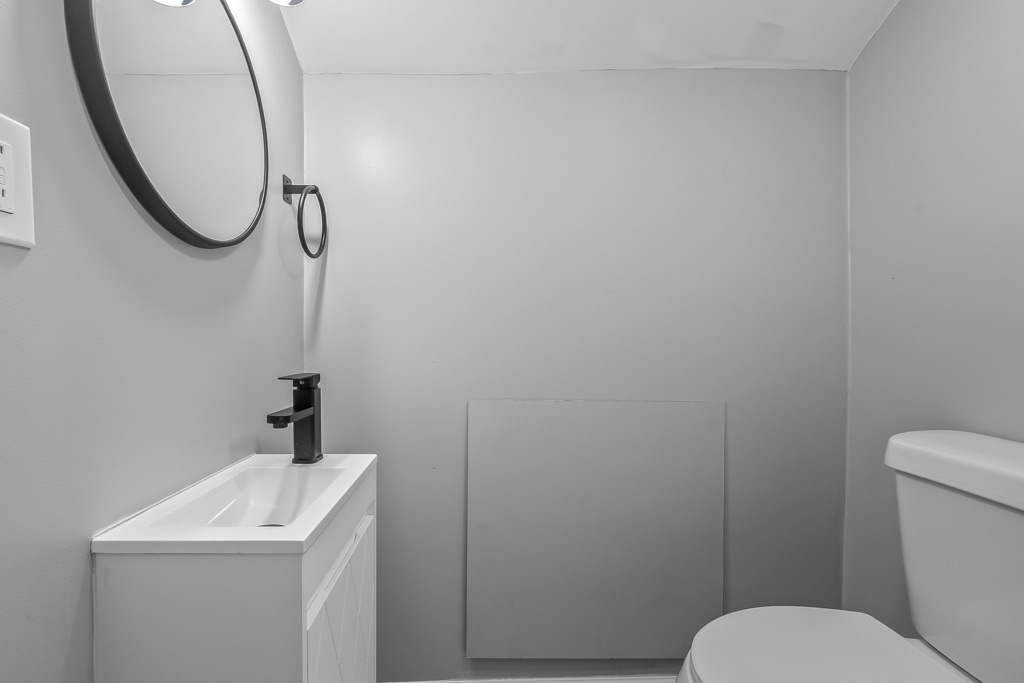 Bathroom vanity after renovation with black faucet and new fixtures.